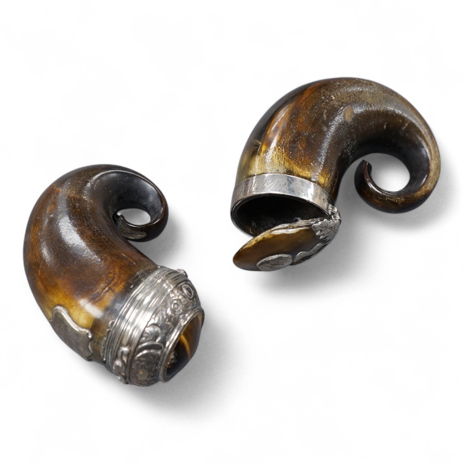 Two 19th century white metal mounted horn snuff mulls, one engraved 'John Calder', the other with inset tiger's eye quartz cabochon, both a.f., largest 83mm.